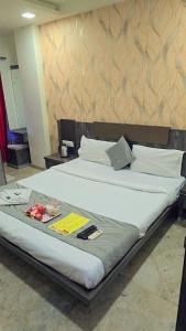 a large bed in a room with at Hotel Krishna in Nagpur +10 photos