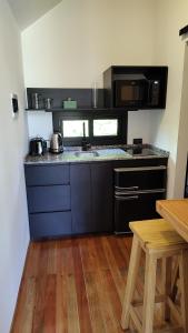 a kitchen with a sink and a counter top at Refugios de Rio Ilo in Concepción del Uruguay