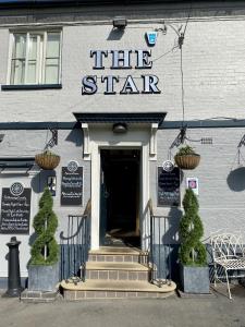 a building with a sign that reads the star at The Star Inn 1744 in Thrussington
