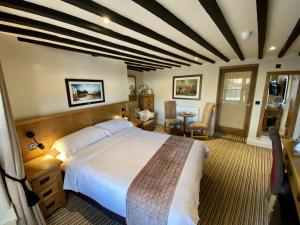 a bedroom with a large bed and a table at The Star Inn 1744 in Thrussington