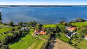 an aerial view of a house next to a lake at Charming apartment by forest & beach on Tåsinge in Svendborg