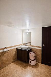 a bathroom with a sink and a mirror at Shwetik Resort in Khamshet