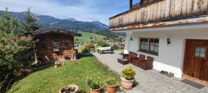 a backyard of a house with a yard with plants at Chalet Edelweiß in Achenkirch