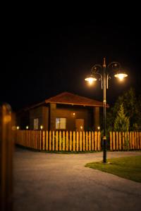 a street light in front of a house with a fence at Shwetik Resort in Khamshet