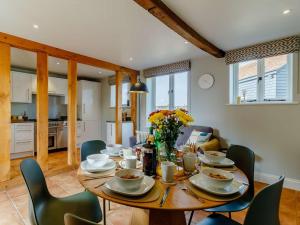 a dining room with a wooden table and chairs at 3 Bed in Saxmundham oc-89691 in Aldringham +12 photos