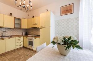 a kitchen with a vase of flowers on a table at VILLA MAGNOLIA in Cavallino-Treporti