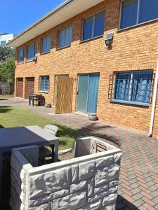a brick building with a table in front of it at 6 Bayview Seaside Apartment in East London