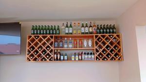 a shelf with bottles of alcohol on a wall at Timeless Residency in Zanzibar City