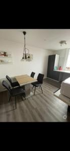 a dining table and chairs in a living room at Haus Cronenberg im Harz in Wernigerode