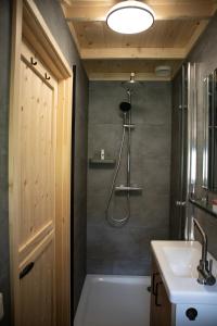 a bathroom with a tub and a sink and a shower at Kapschuur in Zuidwolde