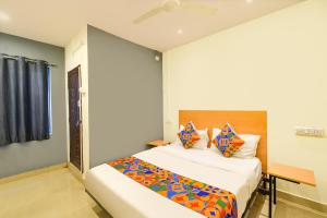 a bedroom with two beds in a room at FabHotel Vedhanshi in Hyderabad