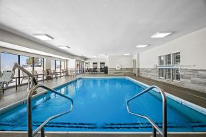a large swimming pool with blue water in a building at Hampton Inn Bloomington West in Bloomington