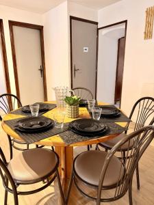 a dining room table with chairs and a wooden table at Le Thylleul - Centre-ville, parking in Albertville +22 photos