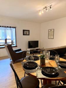 a living room with a table and chairs at Le Thylleul - Centre-ville, parking in Albertville