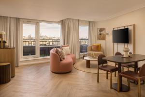 a large living room with a view of a city at Hilton Newcastle Tyne Bridge in Newcastle upon Tyne