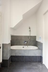 a bathroom with a tub in the corner of a room at Independent house private garden in Milan +33 photos