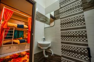 a bathroom with a sink and bunk beds at Rayzen Stays & Backpackers Hostel in Chennai +56 photos