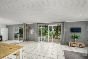 an open living room with a table and sliding glass doors at 302 On Old Sea View Road Chelsea in Port Elizabeth