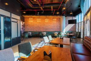 a restaurant with tables and chairs and a brick wall at DoubleTree by Hilton Dubai Port Saeed in Dubai