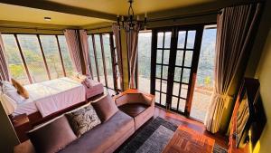 a living room with a couch in front of a window at The Rusty Villa in Hatton