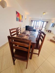 a dining room table and chairs in a room at Ocean Crown Apartments in Mombasa