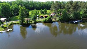 an aerial view of a lake with houses and trees at Kemp Karvánky in Dráchov