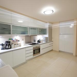 a large kitchen with white cabinets and appliances at Alpha Luxury Villa - Private Pool & VIP Services in Platanias