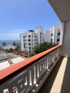 a balcony with a view of the ocean and buildings at Ocean Crown Apartments in Mombasa