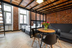 a room with a table and chairs and a brick wall at Pod Błękitnymi Podkowami in Wrocław
