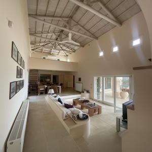 a living room with a couch and a table at Alpha Luxury Villa - Private Pool & VIP Services in Platanias