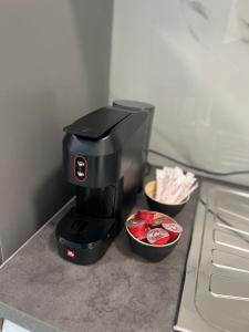 a coffee maker sitting on a counter next to two cups at Geomelos Theodoros Apartments in Chios