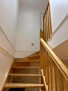 a staircase in a house with wooden steps at Appartement duplex T3 avec box - Paris - La Défense - Airport CDG - Parc des expositions - Stade de France - Disney - Astérix - Val D Europe in Villepinte +3 photos