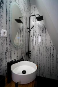 a bathroom with a white bath tub and a mirror at Chalet Alex in Fundata +37 photos
