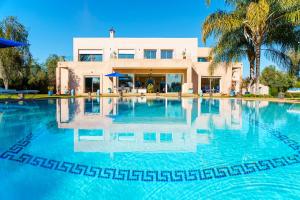 a large swimming pool in front of a house at Palais Pyar Luxury and Serenity Setting in Najem