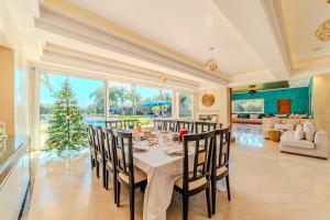 a dining room with a table and a christmas tree at Palais Pyar Luxury and Serenity Setting in Najem