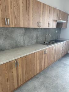 a kitchen with wooden cabinets and a sink at Mieszkateria in Piotrków Trybunalski
