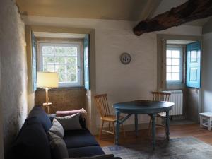 a living room with a couch and a table at Quinta da Coutada - AgroTurismo in Arcos de Valdevez