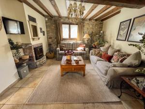 a living room with a couch and a table at Casa Rural Tío Conejo in San Román de Cameros