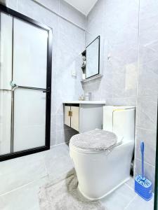 a white bathroom with a toilet and a sink at The Kilimani Executive Studio Haven with Gym&Restaurant in Nairobi +15 photos