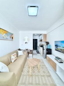 a living room with a couch and a table at The Kilimani Executive Studio Haven with Gym&Restaurant in Nairobi