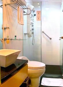 a bathroom with a sink and a toilet and a shower at Hotel King Versalles in Cali +13 photos
