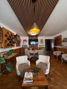 a living room with a wooden ceiling and a table at Chalet MOOS in Todtmoos