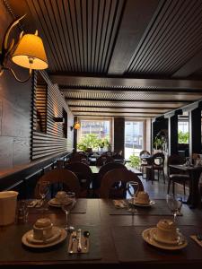 a dining room with a table and chairs in a restaurant at Chalet MOOS in Todtmoos