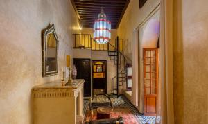 a hallway with a staircase and a chandelier at Riad Sarasvati & SPA in Marrakesh