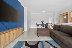 a living room with a couch and a flat screen tv at Ballito Hills 830 in Ballito