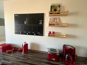 a room with red appliances on the floor with a wall at Hochsitz Appartement in Seelitz +7 photos