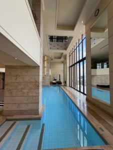 a swimming pool with blue tiles in a building at Michelangelo Towers in Johannesburg