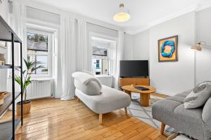 a living room with a couch and a chair and a tv at Wolfe Tone Apartment 2 in Sligo
