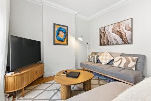 a living room with a couch and a flat screen tv at Wolfe Tone Apartment 2 in Sligo