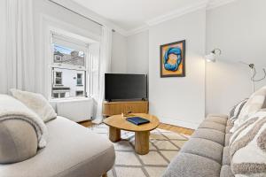 a living room with a couch and a table at Wolfe Tone Apartment 2 in Sligo +20 photos